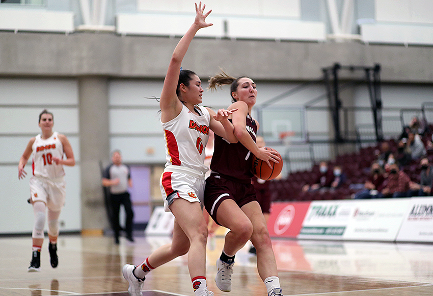Mackenzie Farmer drives to the hoop against Calgary's Mya Proctor. She finished with 12 points and 17 rebounds (Eduardo Perez photo).