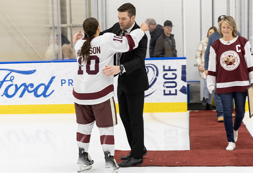 Griffins head coach Chris Leeming, seen embracing 2023-24 captain Sydney Hughson as her graduating senior celebration last season, will be away from the team for the next two weekends coaching Team Alberta at the national U18 women's hockey championship in New Brunswick (Rebecca Chelmick photo).