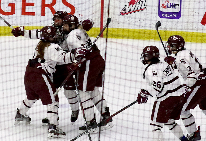 Teammates mob Hailey Maurice after she scored the first Canada West goal in MacEwan women's hockey history on Friday night (Cody Heath photo).