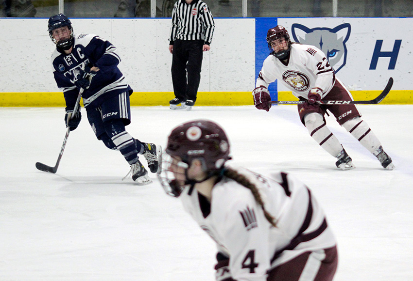 Makenna Schuttler keeps an eye on Robyn Short rushing the puck up the ice on Saturday. It was a true team effort that netted MacEwan a 4-2 win (MRU Athletics photo).