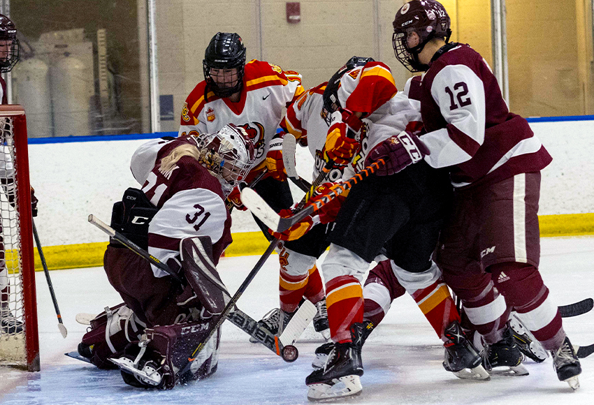 Brianna Sank keeps the puck out in a net-front scramble on Saturday (Derek Harback photo).