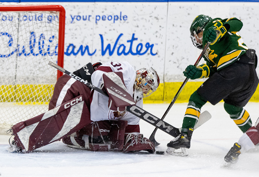 Brianna Sank makes one of her 20 saves in regulation on Saturday night. She broke the program's all-time minutes played record in the first period (Jayna Stoudt photo).