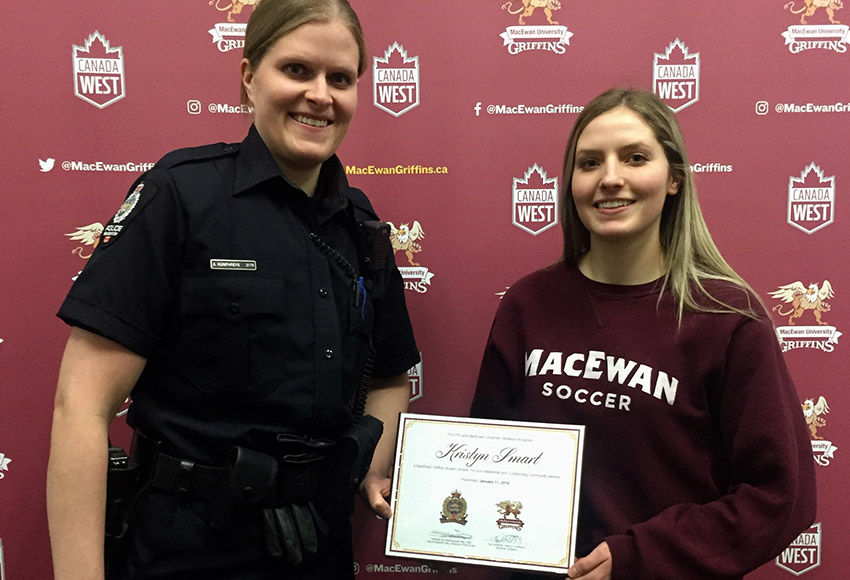 Edmonton Police Service Cst. Amy Humphreys, left, presents an honour certificate to Griffins women's soccer player Kristyn Smart last Friday (Jaelyn Birch photo).