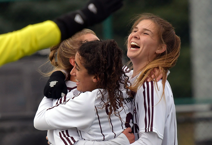 Suekian Choucair and Sunder West mob Salma Kamel, left, after she opened the scoring in the 13th minute on Saturday. She ended up with two goals in a 4-0 MacEwan win (Chris Piggott photo).