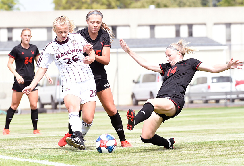 Hannah Supina makes a pass under pressure from Eastern Washington player Madison Kem during their exhibition match on Aug. 17 in Cheney, Wash. (Photo courtesy EWU Athletics).