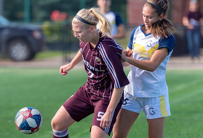MacEwan's Jamie Erickson battles Trinity Western's Aliya Coy during a match earlier this season. The two squads play in separate semifinals on Friday at Clarke Stadium (Chris Piggott photo).