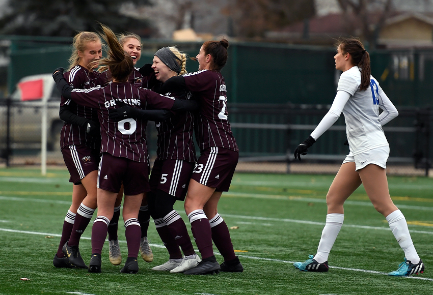 Teammates surround Jamie Erickson after she scored the game-winner in the 42nd minute on Sunday to deliver a 1-0 win over Victoria (Chris Piggott photo).