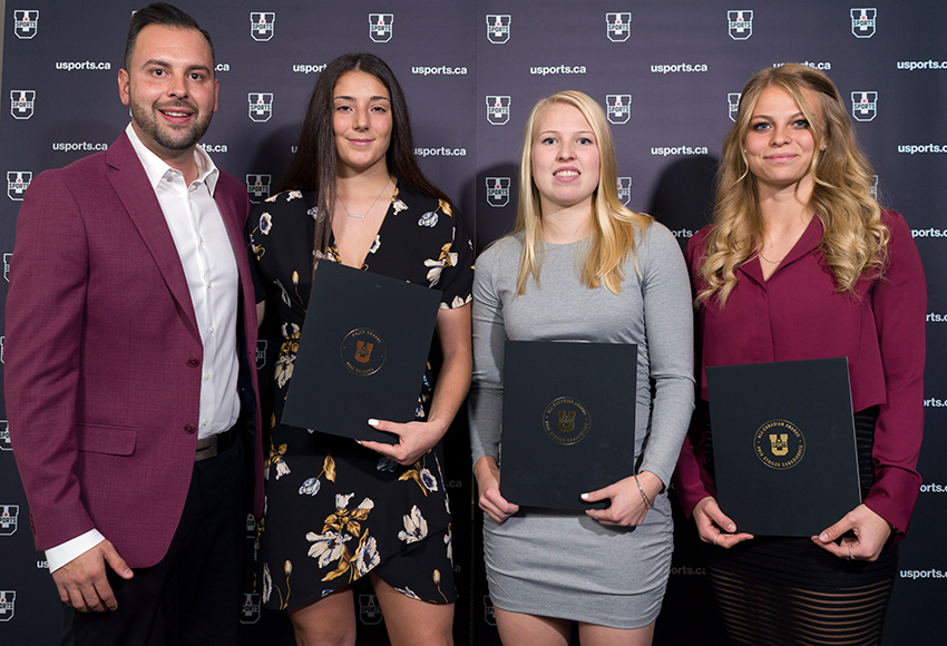 Griffins women's soccer head coach Dean Cordeiro, left, poses with Sofia DiGiacomo (U SPORTS All-Rookie team), Jamie Erickson (U SPORTS First Team All-Stars) and Emily Burns (U SPORTS Second Team All-Stars) at the championship banquet in Victoria on Wednesday night (Armando Tura photo).