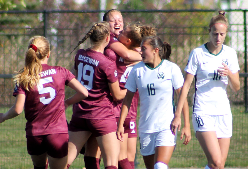 Abbey Wright is mobbed by teammates after scoring the game-winning goal in Sunday's 4-1 victory over the Alberta Pandas (Jefferson Hagen photo).