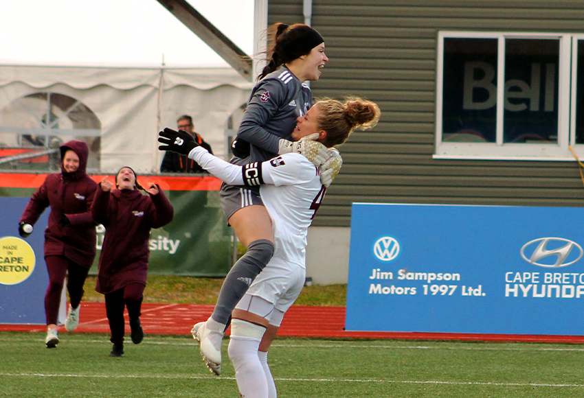 Breanna Truscott leaps into the arms of Griffins captain Samantha Gouveia after the Griffins beat UBC 1-0 in the U SPORTS semifinal on Saturday (Jefferson Hagen photo).