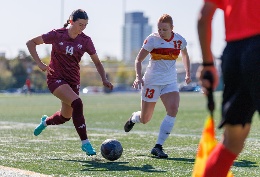 Anneke Odinga carries the ball past Calgary's Jaden Tomaszewski in action between the teams last month at Clarke Stadium. They will play in Calgary on Saturday (Joel Kingston photo).