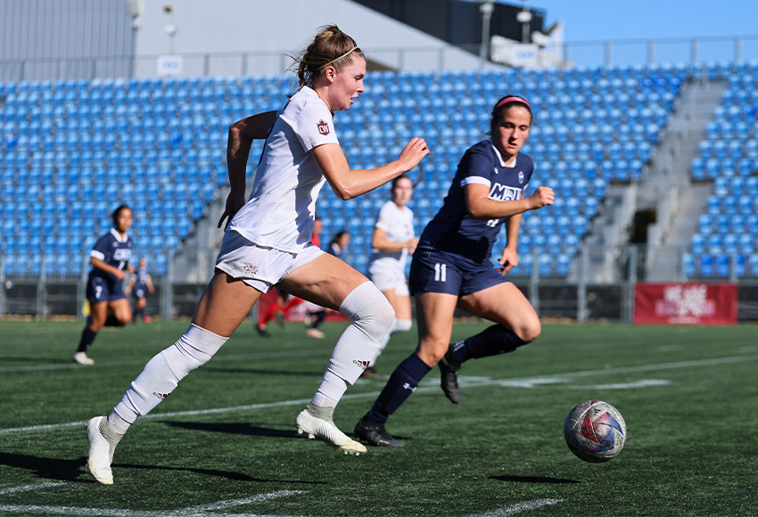 Brenna Paquin runs past a defender on the right flank Sunday. Paquin was credited with the game-winner, scored back on Sept. 16, as MacEwan completed the match and won 3-1 (Joel Kingston photo).
