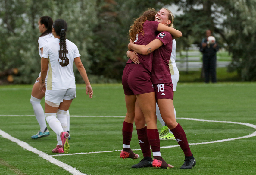 Alyx Henderson gets a huge from Amelia Russo after scoring her 17th career Canada West regular season goal  - a 17th-minute banger than proved to be the game-winner in a 3-1 victory over Manitoba (Dave Mahussier photo).