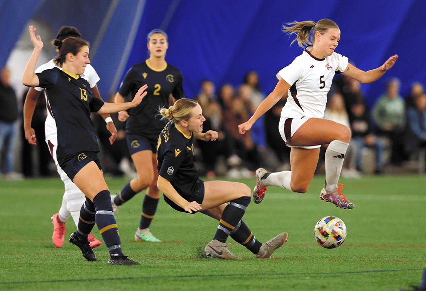 Brynn Hobal flies over the Trinity Western defence during Friday's match. The Griffins lost 2-1 in an evenly-played match that could have gone either way (James Maclennan photo).