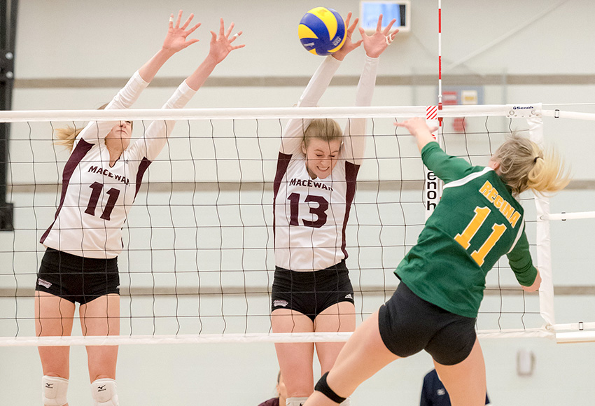 Cassidy Kinsella (13) and McKenna Stevenson (11) block Regina's Haley Wagar during a match last month. Against Calgary on Friday, Kinsella had 21 kills and 22.5 points to move into third on the Canada West career list in both categories (Chris Piggott photo).