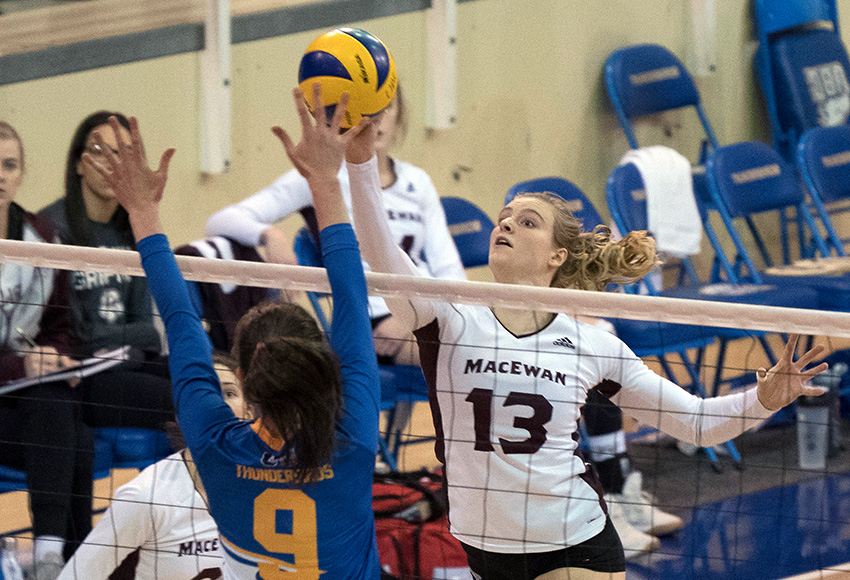 Cassidy Kinsella tips one over Ciara Hanley's block attempt on Saturday night. Kinsella had a game-high 19 kills in the Griffins' 3-2 loss at UBC (Rich Lam / UBC Thunderbirds).