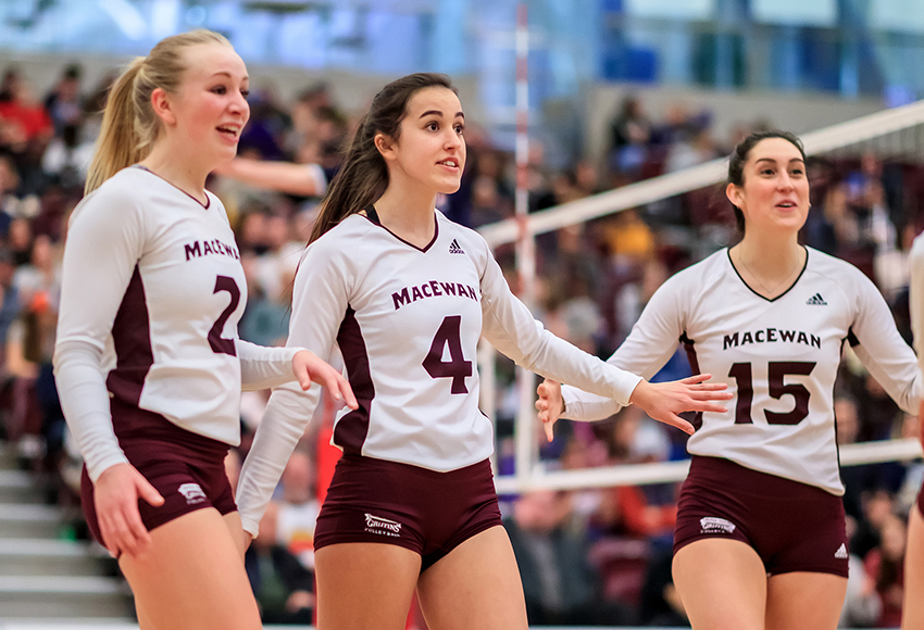 Hailey Cornelis, left, Jordyn Thomas and Lauren Holmes celebrate a point in a match earlier this season. The 16-6 Griffins have moved into the U SPORTS top 10 for the first time this season (Robert Antoniuk photo).