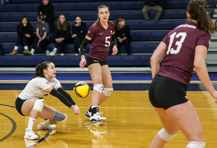 Bronwyn Ettinger passes a ball with teammates Mariah Bereziuk (#5) and Sarah McGee (#13) looking on Friday in Langley, B.C. (Mark Janzen photo).