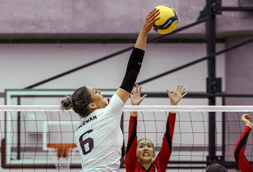 Arden Butler hits against the Winnipeg block on Friday. She led the Griffins with eight kills and was one of only two MacEwan attackers with positive efficiency numbers (Gavin Clarke photo).