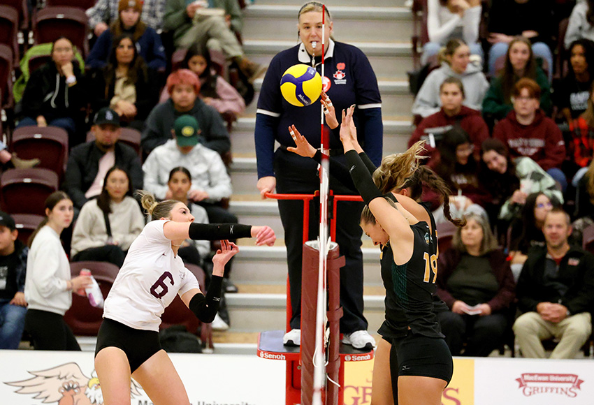 Arden Butler hits against the Pandas' block on Friday night (James Maclennan photo).