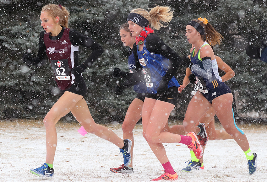 Kiana Row, left, races during the snowy Canada West championship in Calgary last month. She'll be looking for a faster time in the women's 8K race in Kingston, Ont. on Saturday (David Moll / Calgary Dinos photo).