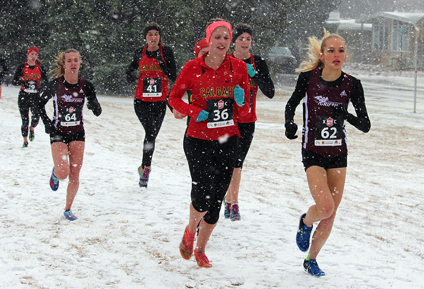 Kiana Row, right, and Griffins teammate Emma Steele, left, run on a snowy race course Saturday (Linda Miller photo).