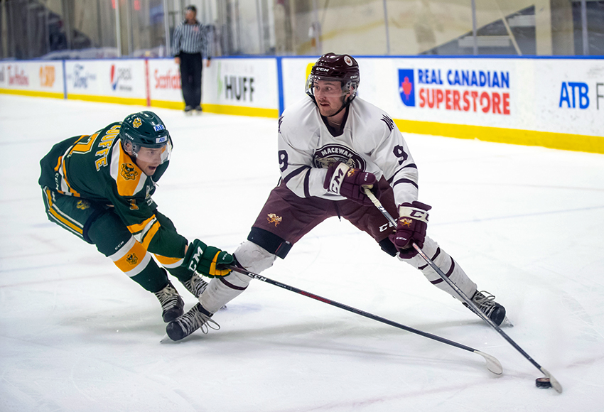 Zach Webb is under heavy pressure from Alberta's Dylan Plouffe during Friday's game at the DCA. MacEwan lost both to their Edmonton rivals (Eduardo Perez photo).