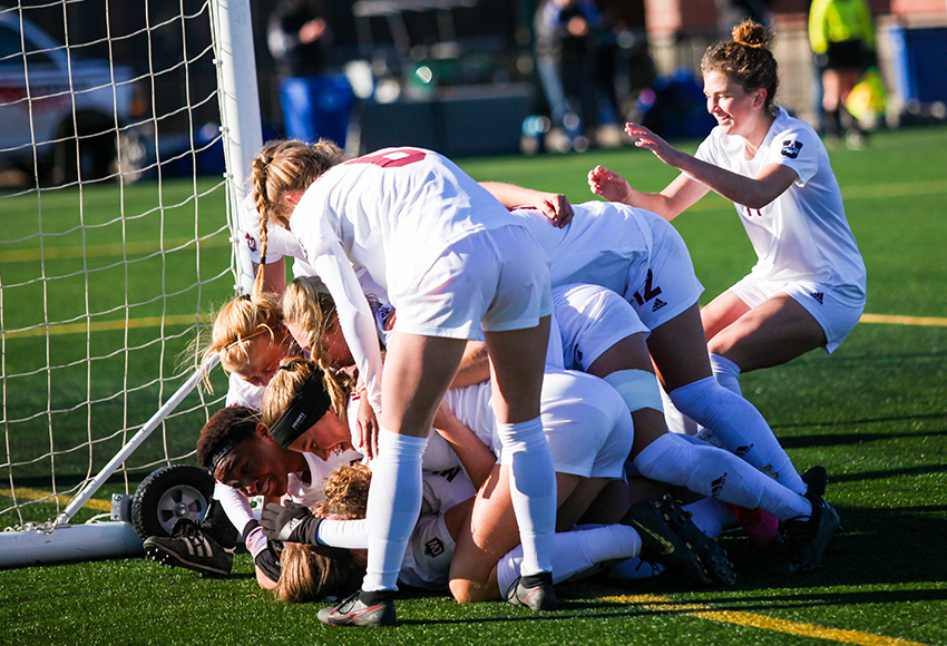 Griffins players pile on in celebration after Abbey Wright opened the scoring in the 37th minute (Tia Schram photo).