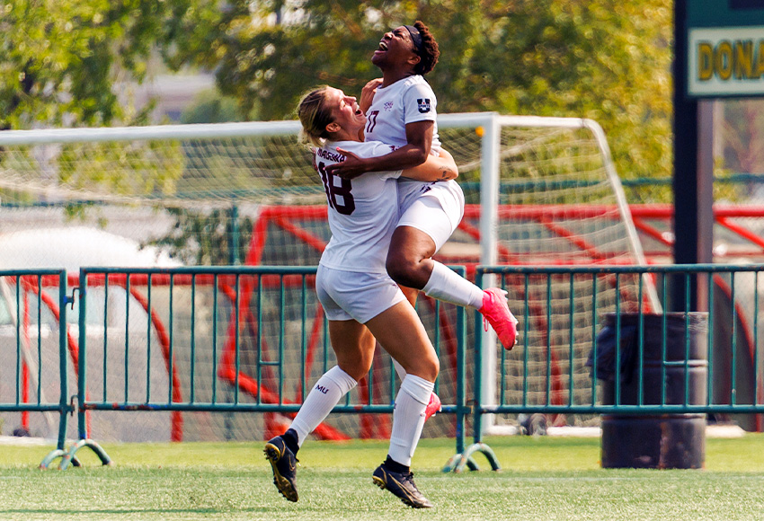 Grace Mwasalla leaps into the arms of Alyx Henderson after scoring the game-winner in extra time (Joel Kingston photo).